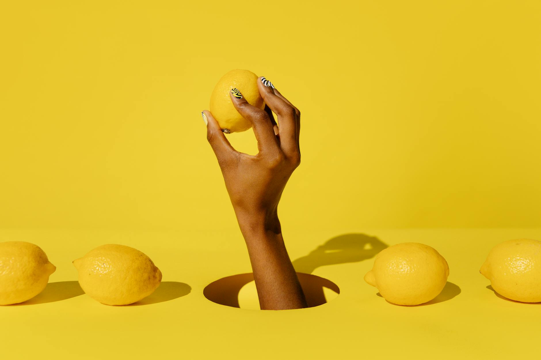 A yellow silicone vibrator surrounded by peeled bananas on a yellow background