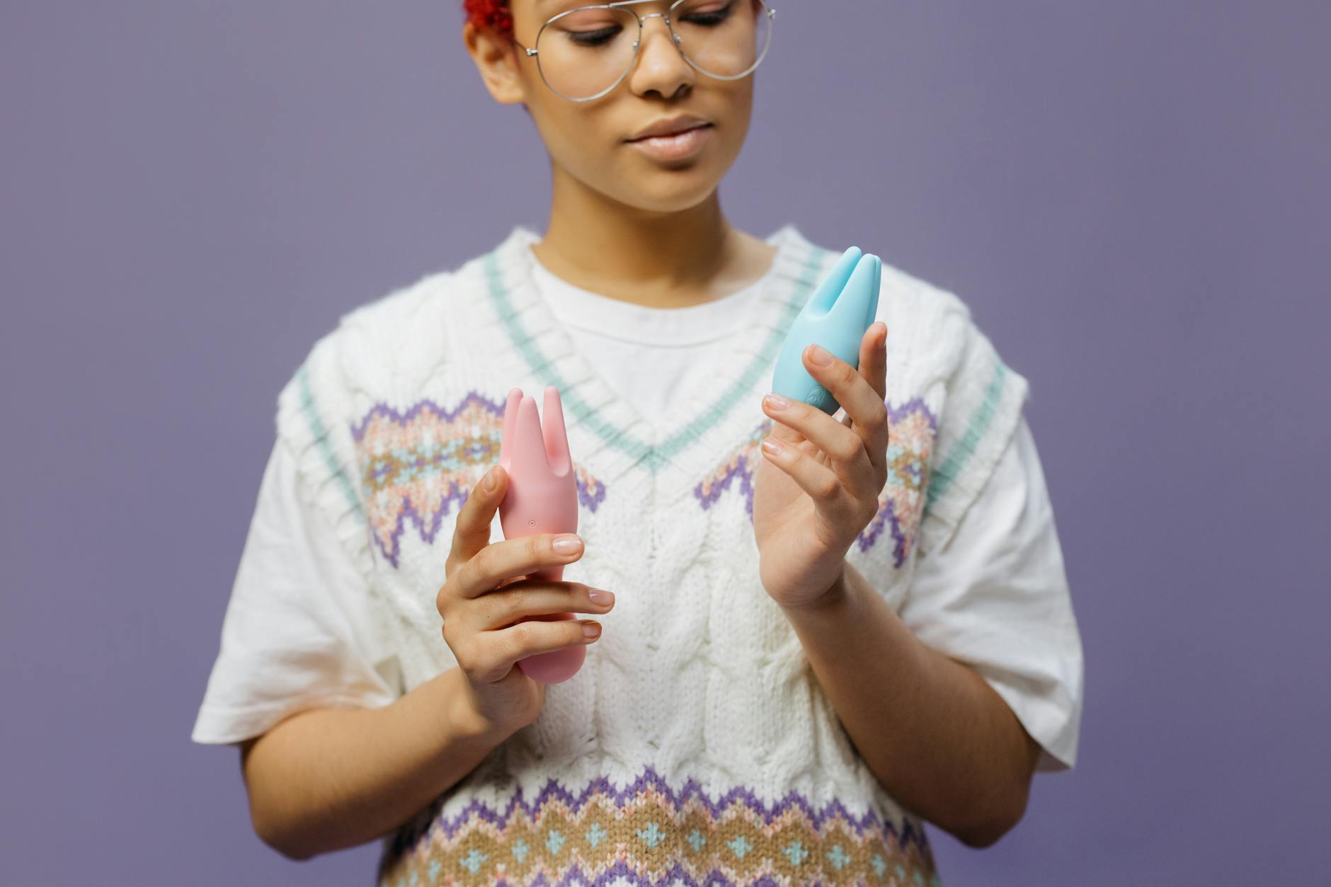 Person holding colorful lemon vibrators in hands, exploring personal pleasure options.