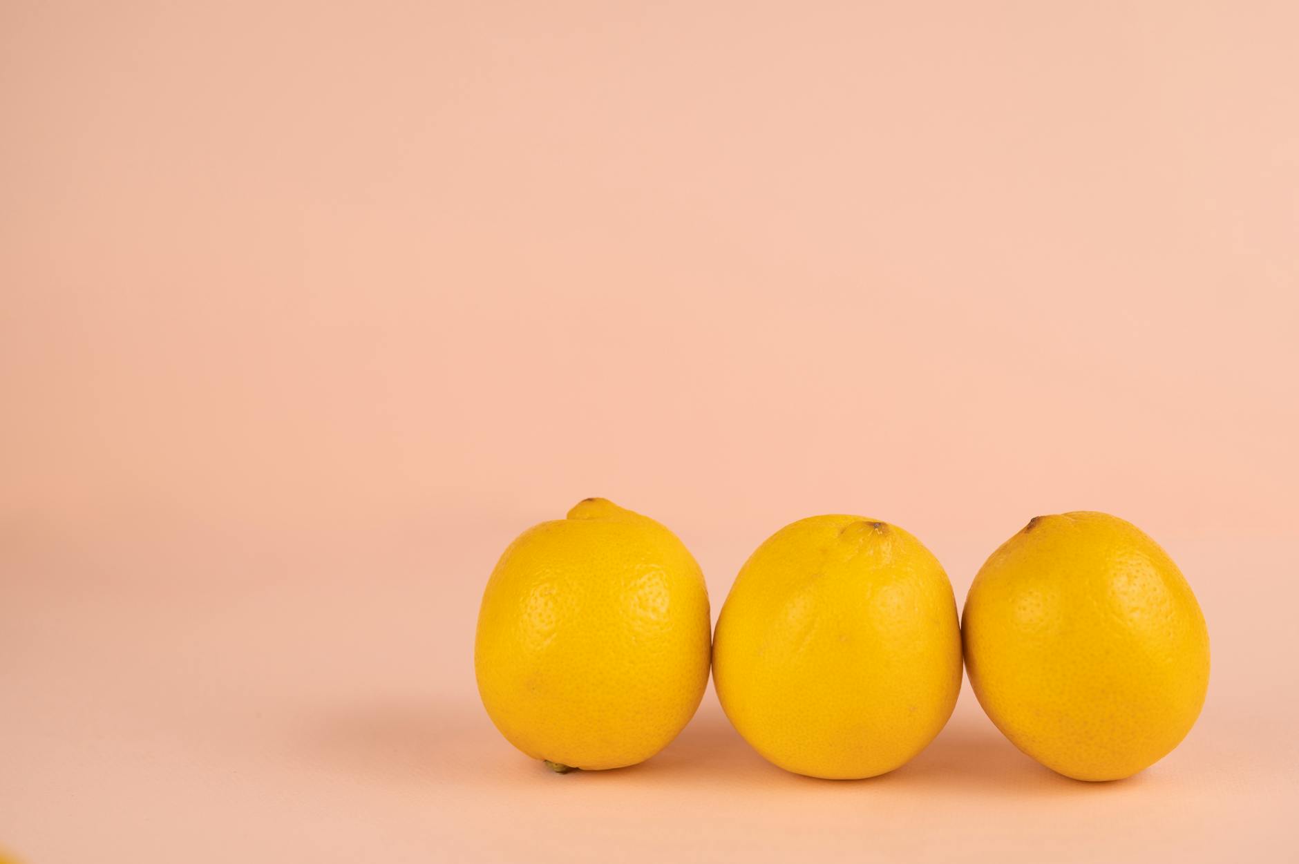 Bright ripe lemons arranged on a pastel background, symbolizing the enduring pleasure through life's transitions